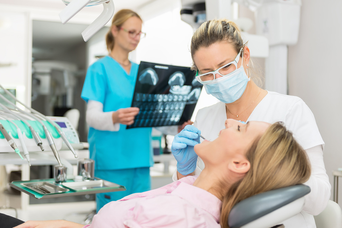 Woman getting checked by dentist image