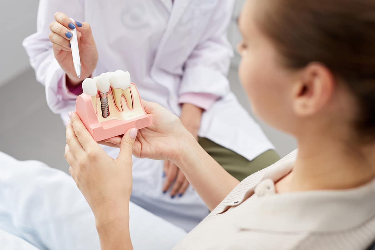 Woman looking at dental implant example image